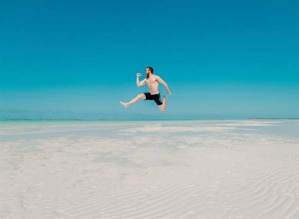 time lapse photography of man jumping at seashore